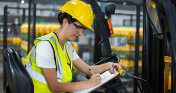 66017a094b43f94f91c8aac6_2021_08_female-factory-worker-sitting-on-forklift-and-writing-in-clipboard-at-factory_1988_1051.jpeg
